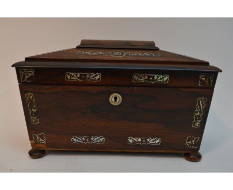 A rosewood sarcophagus shaped tea caddy inlaid with mother of pearl