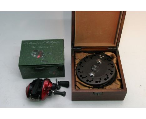 Two boxed Holland and wilkinson reels, a red pro Baitcaster and a gold centerpin in original box (2)