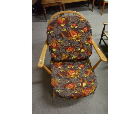 An Ercol light wood Windsor suite comprising low settee, two matching chairs and a stool