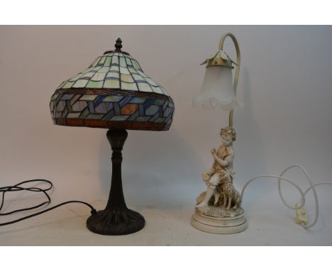 A Tiffany style table lamp and a figural lamp depicting a boy and a dog (2).
