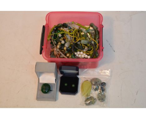 A small tub containing jade type jewellery including gold mounted earrings and a silver ring