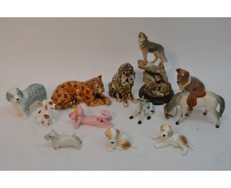 A collection of ceramic animals comprising mainly dogs.