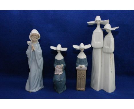 Three Lladro figures of nuns plus a Nao figure of a girl praying (4).