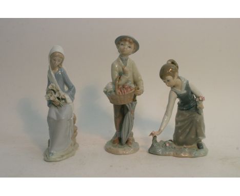 Three Lladro figures with flowers