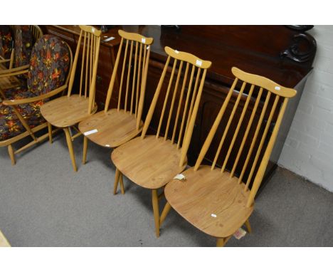 Four light wood Ercol Goldsmith chairs.