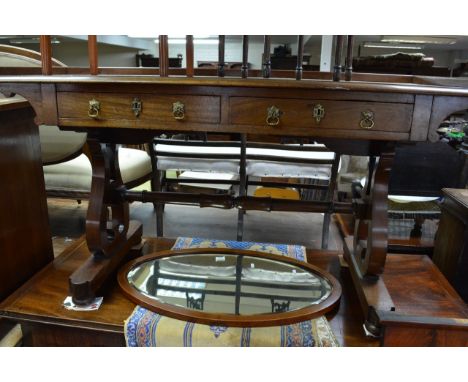 A Victorian mahogany sofa table fitted with two drawers on shaped supports united by a stretcher