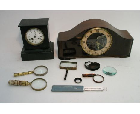 A small slate mantle clock and one other plus a collection of magnifying glasses