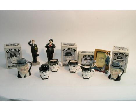 A collection of boxed ceramic Laurel and Hardy and Charlie Chaplin teapots and collectables including two Toby Wood character