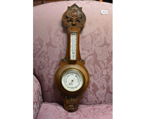 An Oak carved Barometer with applied thermometer box