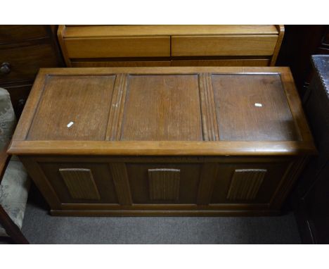 A light wood blanket box.