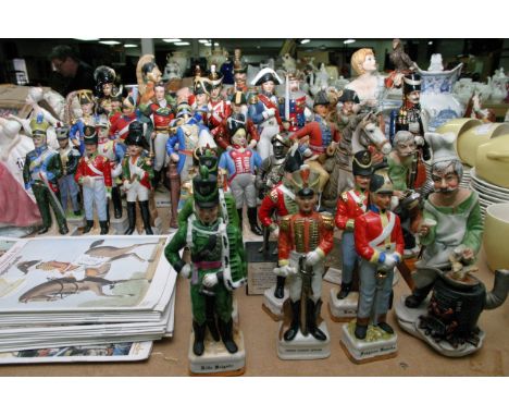 A collection of ceramic soldiers and Capodimonte figures.