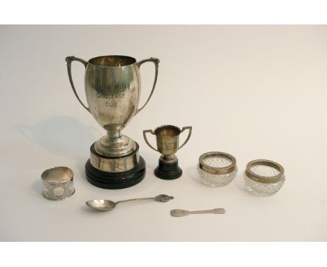 A bag of silver items including two trophy cups, spoon, napkin ring etc.