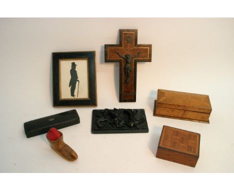 A 19th century silhouette portrait of a gentleman, a relief carved hardstone plaque of a dragon, an inlaid wooden crucifix an