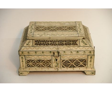 A 19th Century Indian bone casket with fret work panels on shaped bracket feet A/F damage to one foot