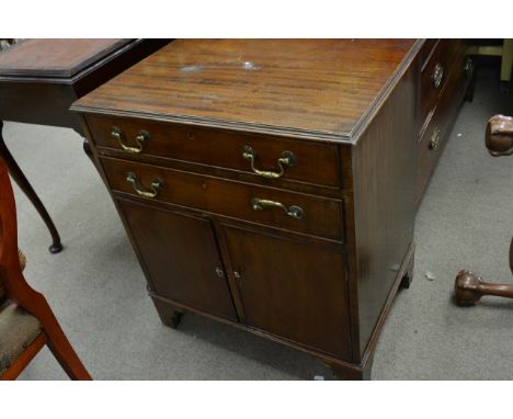 A George III mahogany cabinet fitted with two drawers with cupboards under bracket feet