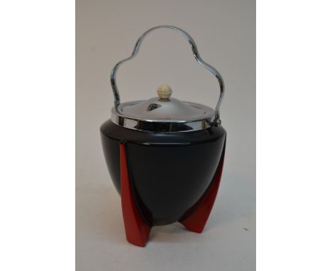 An Art Deco Wilkinson 'Yoo Hoo' pattern biscuit barrel having black body on red fin shaped feet with chrome lid and handle, d