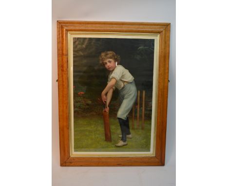 A maple framed print of a young boy playing cricket