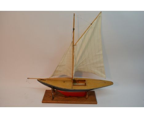 A wooden scale model replica of a yacht.