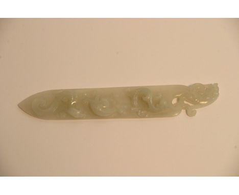 A Chinese white jade paper knife with relief carved decoration. Approximately 20cm long