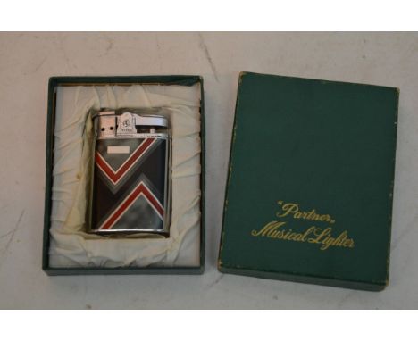 A boxed Art Deco design musical lighter