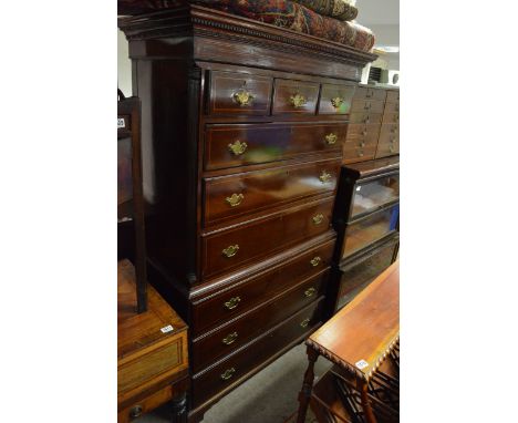 A George III mahgaony and crossbanded chest on chest with three small drawers above a flight of six drawers on bracket feet