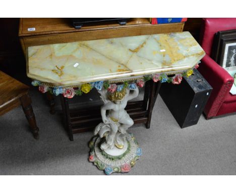 An onyx console table with base in the form of a cherub.
