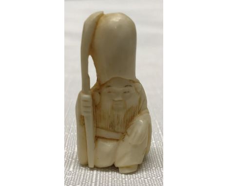 Japanese ivory netsuke, figure of a monk holding a staff. 4cms h.Condition ReportVery good condition.&nbsp;