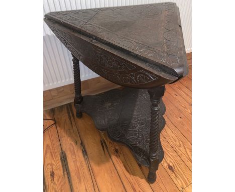 Carved oak drop leaf occasional table on three turned supports. Triangular in shape opening to a round. 74d cms.Condition Rep