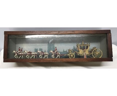 Queen Elizabeth silver jubilee coach and horses in a glazed display case. 62 w x 18cms h. Condition ReportLight surface to we