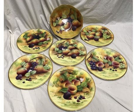 Brookdale Fine Bone China, Fruit bowl 26cms w x 11.5cms h and six decorative plates 28cms w. One plate with a gilt wear patch