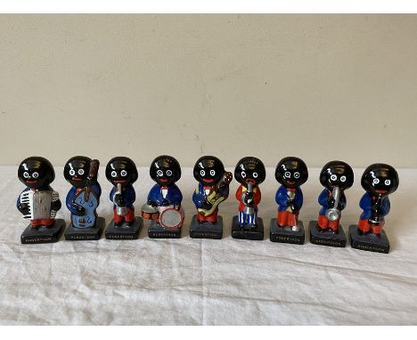 A group of 9 ceramic glossy Band  Robertson Golly figures, possibly Carlton Ware. 9 marked at front 'Robertson', one unmarked