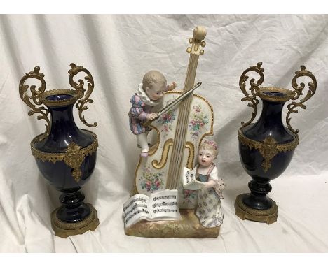 Decorative continental porcelain vase, young boy and girl playing a bass and singing from a song sheet, 32cms h, base width 1