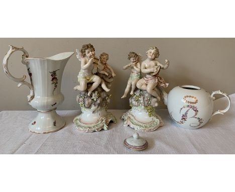 Continental porcelain to include putti figurines, playing instruments, 20cms h, a teapot, jug and a polychrome seated dog. Co