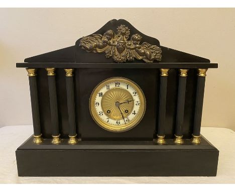 Black slate mantle clock with 6 Corinthian columns. Sounding on a gong, made in France. 42.5cms w x 32ms h x 14.5cms d. Condi