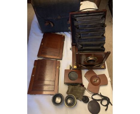 An early 20thC Reynolds and Branson, Leeds mahogany folding plate camera with two lenses and original carry case. 