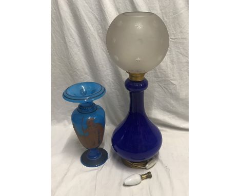 Blue glass table lamp with frosted engraved globe shade. 57cms h and a blue glass vase with Greek warrior design 32cms h. Con