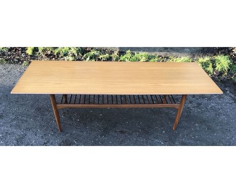 Teak long coffee table with spindled shelf to underneath. 160 l x 58 d x 46 h. Condition ReportSlight split to one edge, othe