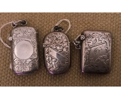 Three hallmarked silver vesta cases, foliage engraved, two with clear cartouche, one initialled S.M. London 1883, 22gms. HP. 