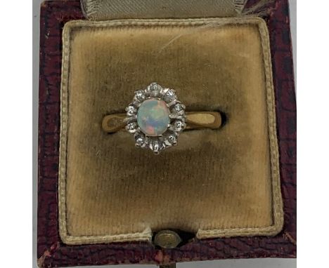 Opal and diamond cluster dress ring set in 18ct gold, size M, 3.6gms total weight. Condition ReportGood condition, no missing