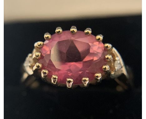 Ladies dress ring set with pink stone and tiny clear stones to each side. Size N, 3.1gms total weight. Condition ReportGood c