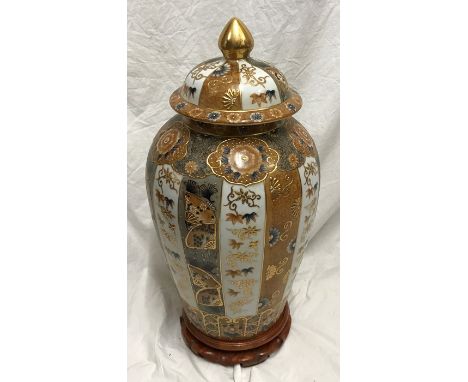 Large Chinese pottery gilt and floral decorated lidded vase on carved wooden stand. 58cms h.Condition ReportLight gilt rub to