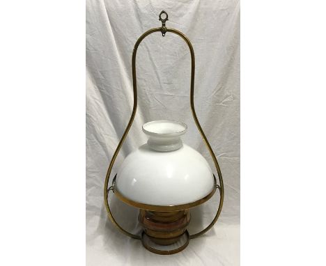 Brass hanging oil lamp with milk glass shade. 64 h x 34 cms w.Condition ReportNo glass chimney flute, overall in a good condi