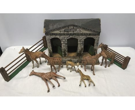 German Elastolin Giraffes and Giraffe house 32 w x 23cms h, seven giraffes, tallest 17cms h with 2 fence sections. Condition 