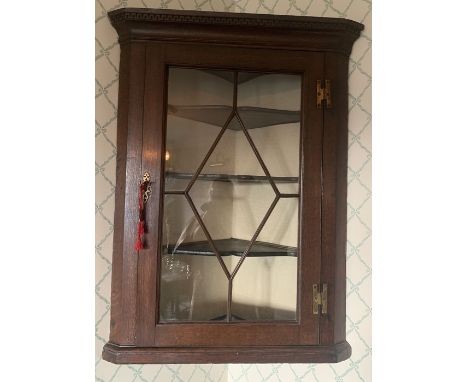 Oak corner cupboard with single glazed door. 92 x 67cms. Condition ReportDamage to one shelf.