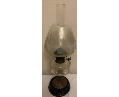 Victorian oil lamp with clear glass reservoir and funnel, brass and black ceramic base and a vaseline glass shade. height to 