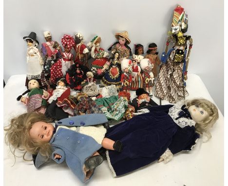 Collection of International dress dolls, a puppet doll and glove puppet, a plastic Famosa doll and a porcelain headed doll. C