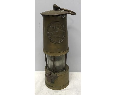 Brass miners lamp The Protector. Eccles, Manchester. 25 h x 8.5cms w. Condition ReportSmall split to brass case at the top ri