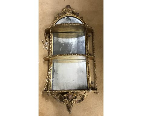Early 19thC gilded mirror backed carved wood framed wall mounted shelf, 91cms h approx 42cms w and 18cms d. 