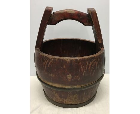 Chinese metal bound wooden bucket with carry handle. 37 h x 32cms w. Condition ReportLoose metal ring, wear patches to stain.