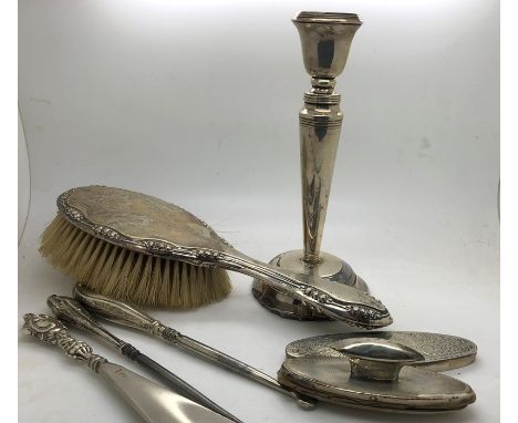 Various hallmarked silver items including candlestick, hairbrush, nail buffers, two silver handled button hooks, silver handl